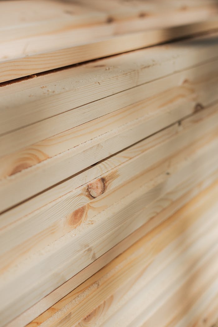 Close-up view of neatly stacked wooden planks highlighting their natural texture and grain.